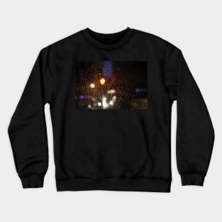 Deatil of raindrops on a car windshield at night Crewneck Sweatshirt